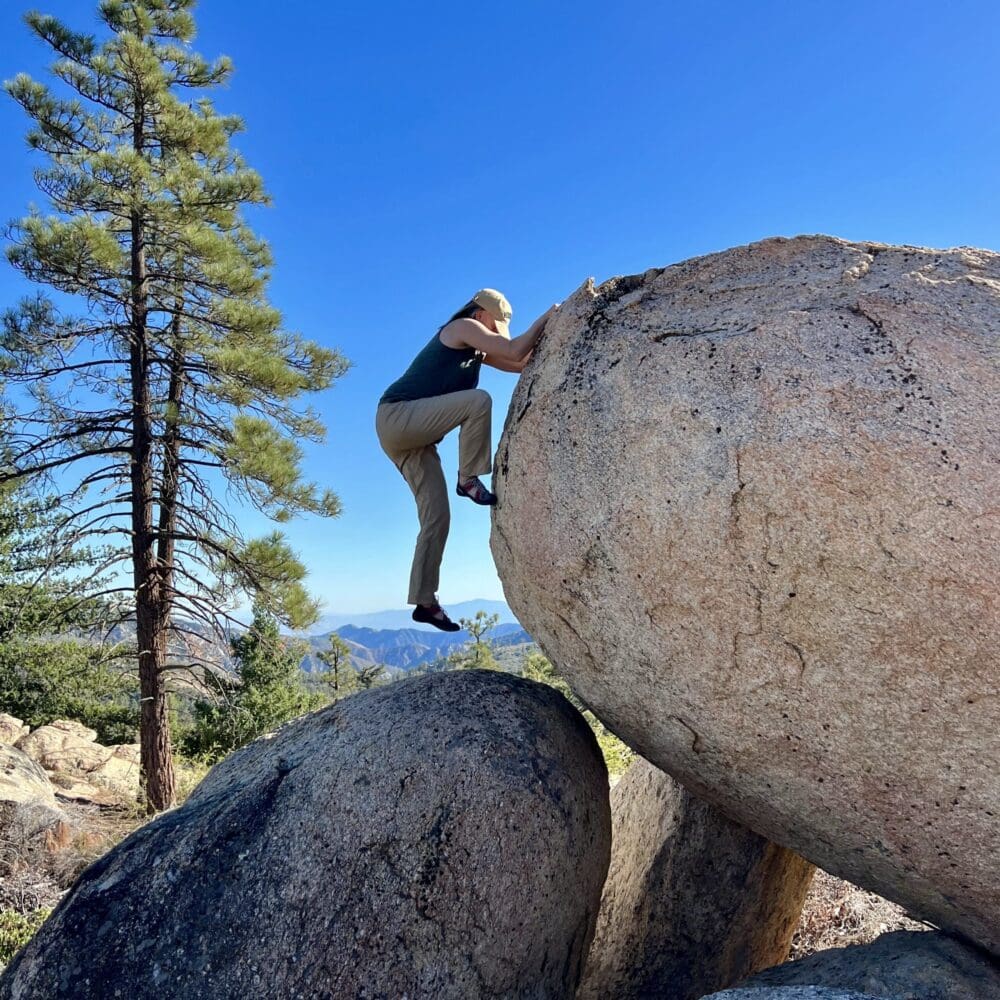 Kathleen struggling up a huge boulder